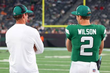 Aug 19, 2023; East Rutherford, New Jersey, USA; New York Jets quarterback Aaron Rodgers (8) and New York Jets quarterback Zach Wilson (2) talk during the second half of their game against the Tampa Bay Buccaneers at MetLife Stadium. Mandatory Credit: Ed Mulholland-USA TODAY Sports