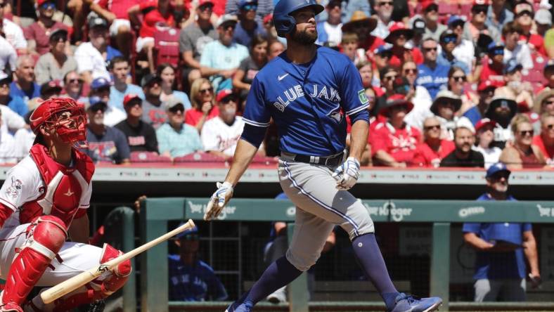 Aug 20, 2023; Cincinnati, Ohio, USA; Toronto Blue Jays designated hitter Brandon Belt (13) hits a two-run home run against the Cincinnati Reds during the second inning at Great American Ball Park. Mandatory Credit: David Kohl-USA TODAY Sports