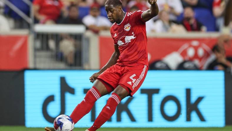 Aug 20, 2023; Harrison, New Jersey, USA; New York Red Bulls defender Andres Reyes (4) kicks the ball against D.C. United during the first half at Red Bull Arena. Mandatory Credit: Vincent Carchietta-USA TODAY Sports