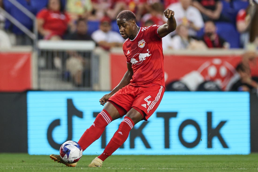 Aug 20, 2023; Harrison, New Jersey, USA; New York Red Bulls defender Andres Reyes (4) kicks the ball against D.C. United during the first half at Red Bull Arena. Mandatory Credit: Vincent Carchietta-USA TODAY Sports