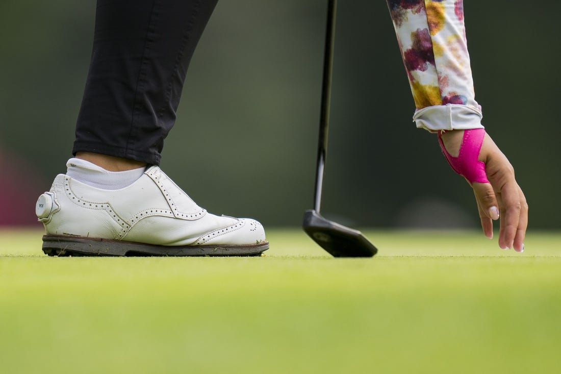 Aug 25, 2023; Vancouver, British Columbia, CAN; Lilia Vu picks her ball out of the hole on the sixth green during the second round of the CPKC Women's Open golf tournament at Shaughnessy Golf & Country Club. Mandatory Credit: Bob Frid-USA TODAY Sports