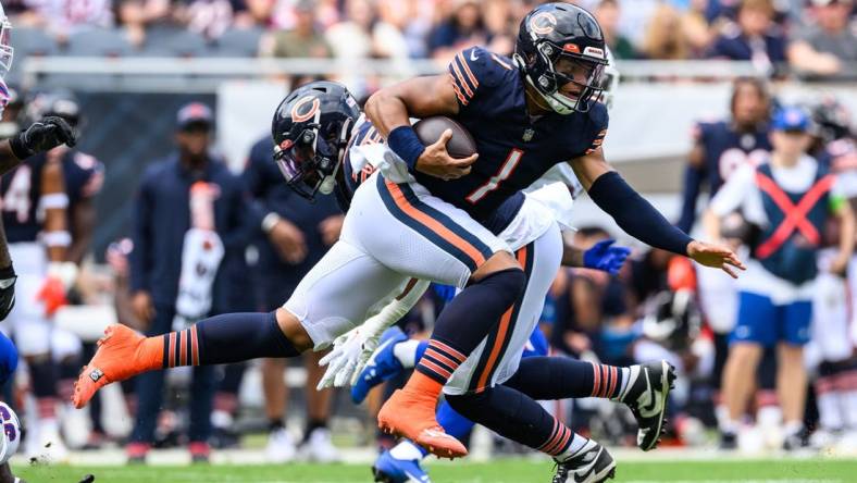 Aug 26, 2023; Chicago, Illinois, USA; Chicago Bears quarterback Justin Fields (1) runs the ball against the Buffalo Bills during the first quarter at Soldier Field. Mandatory Credit: Daniel Bartel-USA TODAY Sports