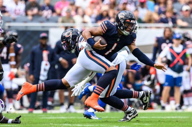 Aug 26, 2023; Chicago, Illinois, USA; Chicago Bears quarterback Justin Fields (1) runs the ball against the Buffalo Bills during the first quarter at Soldier Field. Mandatory Credit: Daniel Bartel-USA TODAY Sports