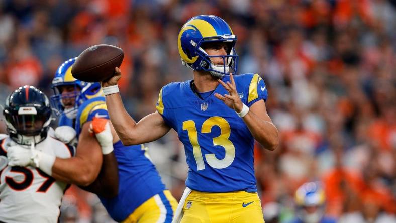 Aug 26, 2023; Denver, Colorado, USA; Los Angeles Rams quarterback Stetson Bennett (13) looks to pass in the first quarter against the Denver Broncos at Empower Field at Mile High. Mandatory Credit: Isaiah J. Downing-USA TODAY Sports