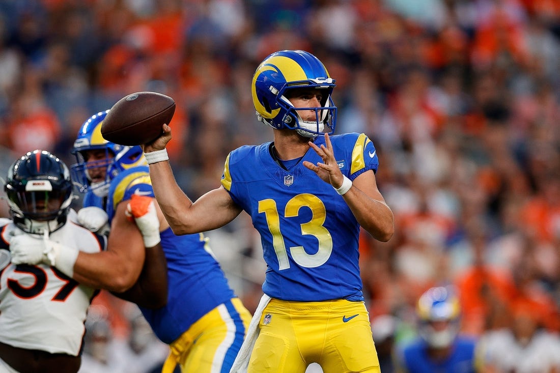 Aug 26, 2023; Denver, Colorado, USA; Los Angeles Rams quarterback Stetson Bennett (13) looks to pass in the first quarter against the Denver Broncos at Empower Field at Mile High. Mandatory Credit: Isaiah J. Downing-USA TODAY Sports