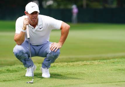 Aug 27, 2023; Atlanta, Georgia, USA; Rory McIlroy lines up his putt on the first green  during the final round of the TOUR Championship golf tournament at East Lake Golf Club. Mandatory Credit: John David Mercer-USA TODAY Sports