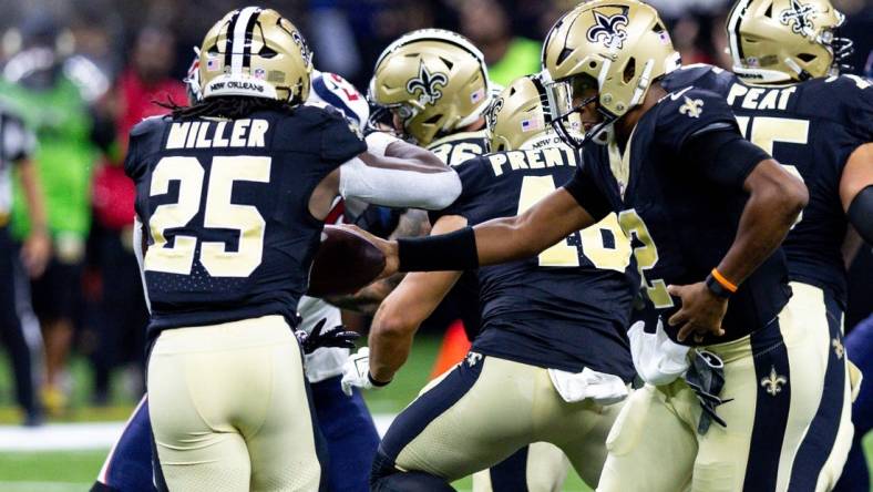 Aug 27, 2023; New Orleans, Louisiana, USA;  New Orleans Saints quarterback Jameis Winston (2) hands the ball off to running back Kendre Miller (25) against the Houston Texans during the first half at the Caesars Superdome. Mandatory Credit: Stephen Lew-USA TODAY Sports