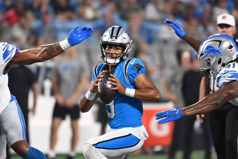 Aug 25, 2023; Charlotte, North Carolina, USA;  Carolina Panthers quarterback Bryce Young (9) is sacked by Detroit Lions linebacker James Houston (41) as defensive end Romeo Okwara (95) helps defend in the first quarter at Bank of America Stadium. Mandatory Credit: Bob Donnan-USA TODAY Sports
