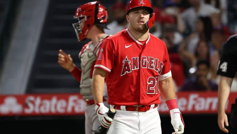 Aug 22, 2023; Anaheim, California, USA;  Los Angeles Angels center fielder Mike Trout (27) walks back to the dugout during the MLB game against the Cincinnati Reds at Angel Stadium. Mandatory Credit: Kiyoshi Mio-USA TODAY Sports