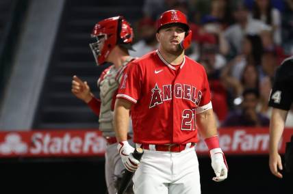 Aug 22, 2023; Anaheim, California, USA;  Los Angeles Angels center fielder Mike Trout (27) walks back to the dugout during the MLB game against the Cincinnati Reds at Angel Stadium. Mandatory Credit: Kiyoshi Mio-USA TODAY Sports