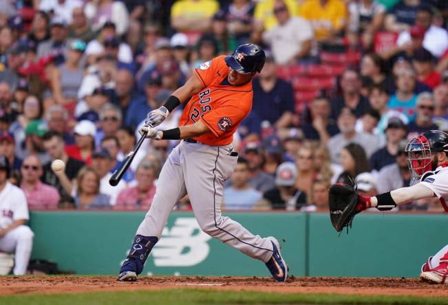 Aug 30, 2023; Boston, Massachusetts, USA; Houston Astros designated hitter Michael Brantley (23) hits a single to right field to drive in two runs against the Boston Red Sox in the third inning at Fenway Park. Mandatory Credit: David Butler II-USA TODAY Sports