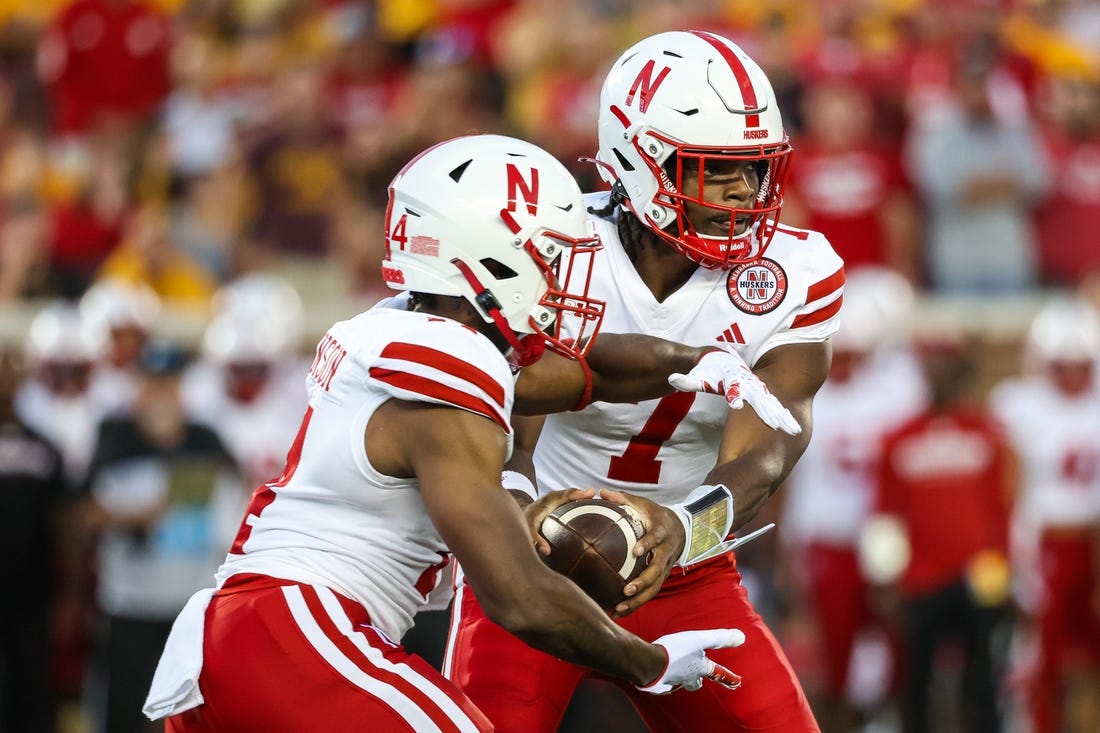 Aug 31, 2023; Minneapolis, Minnesota, USA; Nebraska Cornhuskers quarterback Jeff Sims (7) hands the ball off to running back Rahmir Johnson (14) during the second quarter against the Minnesota Golden Gophers at Huntington Bank Stadium. Mandatory Credit: Matt Krohn-USA TODAY Sports