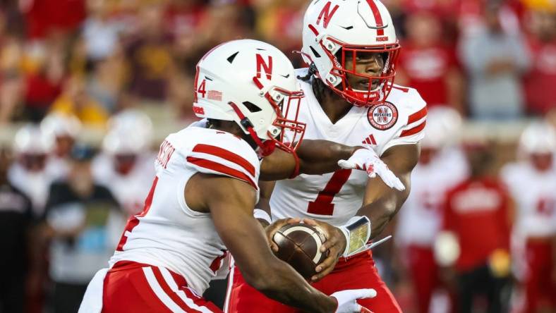 Aug 31, 2023; Minneapolis, Minnesota, USA; Nebraska Cornhuskers quarterback Jeff Sims (7) hands the ball off to running back Rahmir Johnson (14) during the second quarter against the Minnesota Golden Gophers at Huntington Bank Stadium. Mandatory Credit: Matt Krohn-USA TODAY Sports