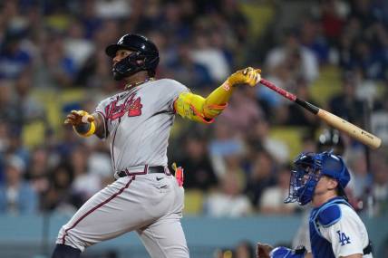 Aug 31, 2023; Los Angeles, California, USA; Atlanta Braves right fielder Ronald Acuna Jr. (13) hits a grand slam home run in the second inning against the Los Angeles Dodger at Dodger Stadium. Mandatory Credit: Kirby Lee-USA TODAY Sports