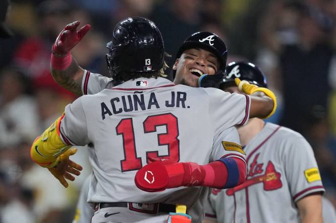 Aug 31, 2023; Los Angeles, California, USA; Atlanta Braves right fielder Ronald Acuna Jr. (13) is greeted after hitting a grand slam home run in the second inning against the Los Angeles Dodger at Dodger Stadium. Mandatory Credit: Kirby Lee-USA TODAY Sports