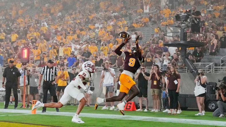 Aug 31, 2023; Tempe, Arizona, USA; Arizona State Sun Devils wide receiver Troy Omeire (9) makes a touchdown catch over Southern Utah Thunderbirds cornerback Jehvonn Lewis (26) during a dust storm in the first half at Mountain America Stadium. Mandatory Credit: Rob Schumacher-Arizona Republic