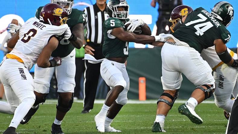 Sep 1, 2023; East Lansing, Michigan, USA;  Michigan State Spartans running back Nathan Carter (5) runs through a hole in the Central Michigan Chippewas line in the second quarter at Spartan Stadium. Mandatory Credit: Dale Young-USA TODAY Sports