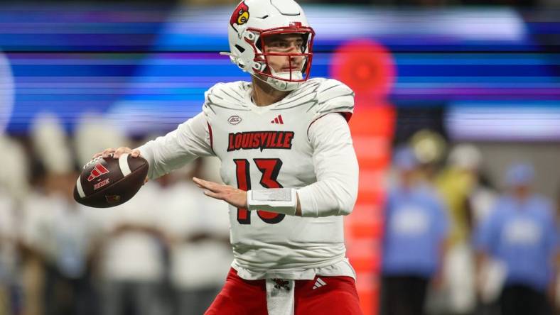 Sep 1, 2023; Atlanta, Georgia, USA; Louisville Cardinals quarterback Jack Plummer (13) looks to throw against the Georgia Tech Yellow Jackets in the second quarter at Mercedes-Benz Stadium. Mandatory Credit: Brett Davis-USA TODAY Sports