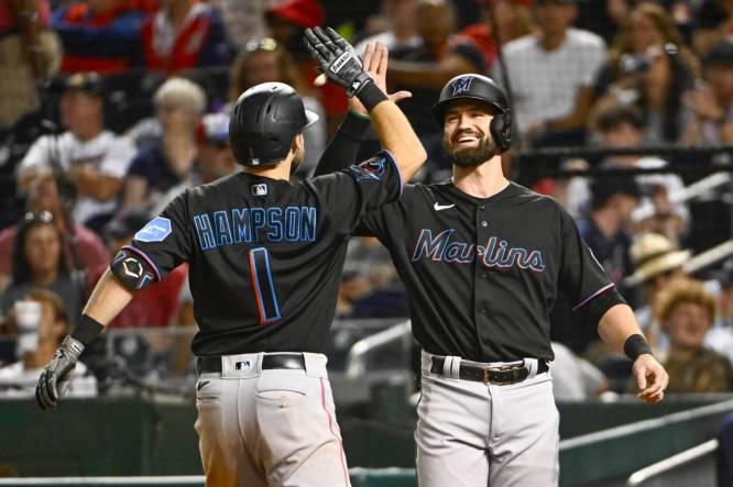 Sep 1, 2023; Washington, District of Columbia, USA; Miami Marlins center fielder Garrett Hampson (1) is congratulated by shortstop Jon Berti (5) after hitting a two run home run during the eleventh inning against the Washington Nationals at Nationals Park. Mandatory Credit: Brad Mills-USA TODAY Sports