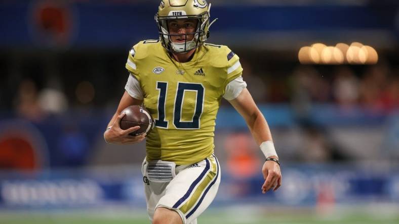 Sep 1, 2023; Atlanta, Georgia, USA; Georgia Tech Yellow Jackets quarterback Haynes King (10) runs the ball against the Louisville Cardinals in the fourth quarter at Mercedes-Benz Stadium. Mandatory Credit: Brett Davis-USA TODAY Sports