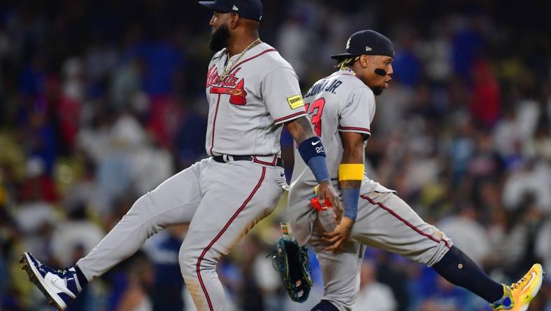 September 1, 2023; Los Angeles, California, USA; Atlanta Braves designated hitter Marcell Ozuna (20) and right fielder Ronald Acuna Jr. (13) celebrate the victory against the Los Angeles Dodgers at Dodger Stadium. Mandatory Credit: Gary A. Vasquez-USA TODAY Sports