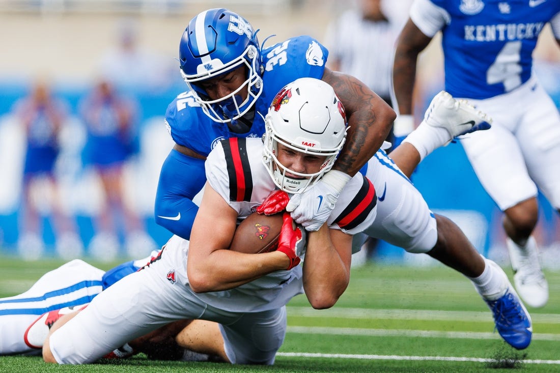 Sep 2, 2023; Lexington, Kentucky, USA; Ball State Cardinals tight end Tanner Koziol (88) is tackled by Kentucky Wildcats linebacker Trevin Wallace (32) during the first quarter at Kroger Field. Mandatory Credit: Jordan Prather-USA TODAY Sports