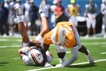 Sep 2, 2023; Nashville, Tennessee, USA; Virginia Cavaliers quarterback Tony Muskett (11) is sacked by Tennessee Volunteers defensive lineman James Pearce Jr. (27) during the first half at Nissan Stadium. Mandatory Credit: Christopher Hanewinckel-USA TODAY Sports