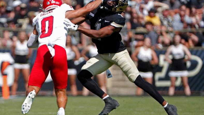 Fresno State Bulldogs wide receiver Mac Dalena (0) stiff-arms Purdue Boilermakers defensive back Markevious Brown (1) during the NCAA football game, Saturday, Sept. 2, 2023, at Ross-Ade Stadium in West Lafayette, Ind.