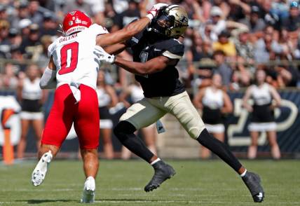 Fresno State Bulldogs wide receiver Mac Dalena (0) stiff-arms Purdue Boilermakers defensive back Markevious Brown (1) during the NCAA football game, Saturday, Sept. 2, 2023, at Ross-Ade Stadium in West Lafayette, Ind.