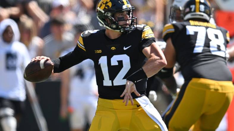 Sep 2, 2023; Iowa City, Iowa, USA; Iowa Hawkeyes quarterback Cade McNamara (12) throws a pass against the Utah State Aggies during the second quarter at Kinnick Stadium. Mandatory Credit: Jeffrey Becker-USA TODAY Sports