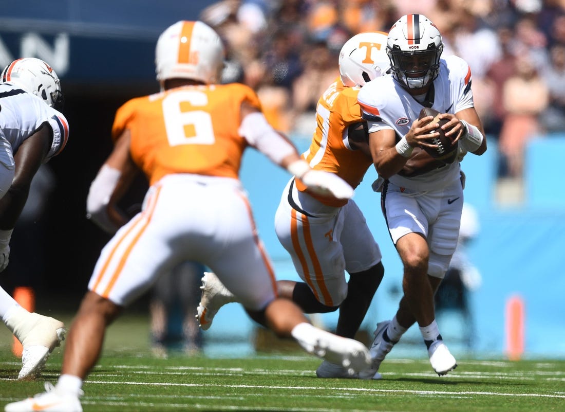 Virginia Cavaliers quarterback Tony Muskett (11) is met by Volunteers defensive lineman James Pearce Jr. (27) during their game at Nissan Stadium Saturday, Sept. 2, 2023.