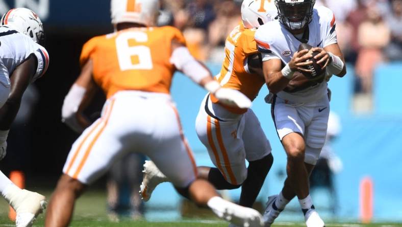 Virginia Cavaliers quarterback Tony Muskett (11) is met by Volunteers defensive lineman James Pearce Jr. (27) during their game at Nissan Stadium Saturday, Sept. 2, 2023.