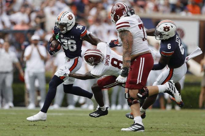 Sep 2, 2023; Auburn, Alabama, USA;  Massachusetts Minutemen wide receiver Anthony Simpson (8) moves in to tackle Auburn Tigers cornerback Jaylin Simpson (36) after Simpson recovered a fumble during the second quarter at Jordan-Hare Stadium. Mandatory Credit: John Reed-USA TODAY Sports