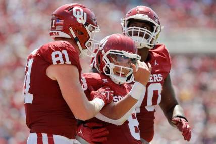 Oklahoma's Dillon Gabriel (8) celebrates beside Austin Stogner (81) and Cayden Green (70) after running for a touchdown during a college football game between the University of Oklahoma Sooners (OU) and the Arkansas State Red Wolves at Gaylord Family-Oklahoma Memorial Stadium in Norman, Okla., Saturday, Sept. 2, 2023.