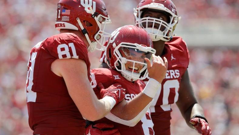 Oklahoma's Dillon Gabriel (8) celebrates beside Austin Stogner (81) and Cayden Green (70) after running for a touchdown during a college football game between the University of Oklahoma Sooners (OU) and the Arkansas State Red Wolves at Gaylord Family-Oklahoma Memorial Stadium in Norman, Okla., Saturday, Sept. 2, 2023.