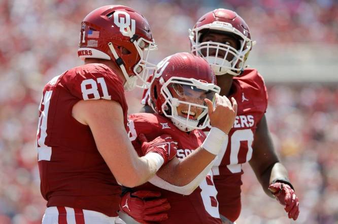 Oklahoma's Dillon Gabriel (8) celebrates beside Austin Stogner (81) and Cayden Green (70) after running for a touchdown during a college football game between the University of Oklahoma Sooners (OU) and the Arkansas State Red Wolves at Gaylord Family-Oklahoma Memorial Stadium in Norman, Okla., Saturday, Sept. 2, 2023.
