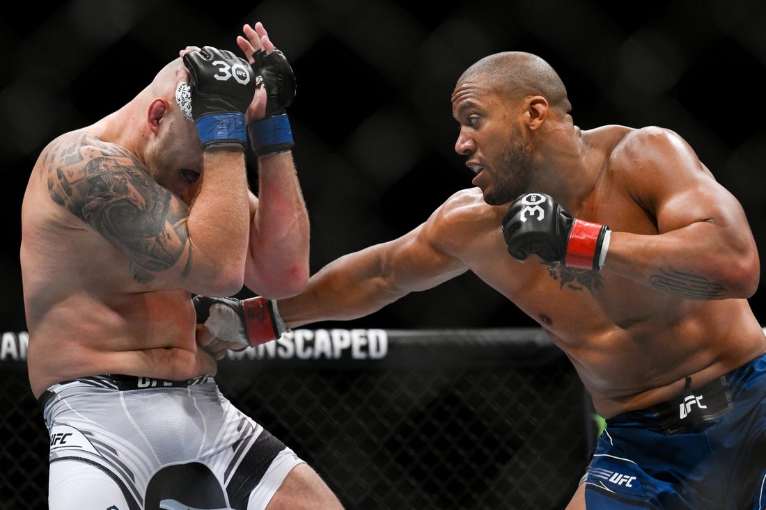 Sep 2, 2023; Paris, France; Ciryl Gane (red gloves) fights Serghei Spivac (blue gloves) during UFC Fight Night at Accor Arena. Mandatory Credit: Per Haljestam-USA TODAY Sports