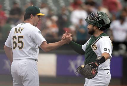 Sep 2, 2023; Oakland, California, USA; Oakland Athletics pitcher Trevor May (65) and catcher Shea Langeliers (23) celebrate their 2-1 victory over the Los Angeles Angels at Oakland-Alameda County Coliseum. Mandatory Credit: D. Ross Cameron-USA TODAY Sports