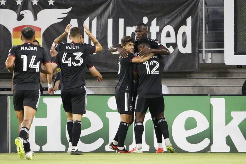 Sep 2, 2023; Washington, District of Columbia, USA; D.C. United forward Christian Benteke (20) celebrates with teammates after scoring a goal against Chicago Fire during the first half at Audi Field. Mandatory Credit: Amber Searls-USA TODAY Sports