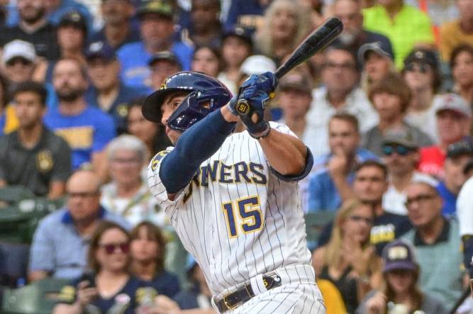 Sep 2, 2023; Milwaukee, Wisconsin, USA;  Milwaukee Brewers right fielder Tyrone Taylor (15) hits a double to drive in a run in the second inning against the Philadelphia Phillies at American Family Field. Mandatory Credit: Benny Sieu-USA TODAY Sports