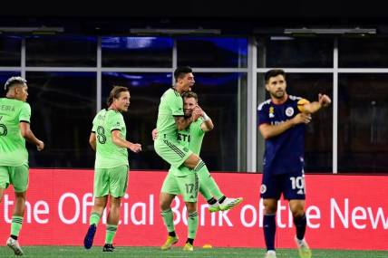 Sep 2, 2023; Foxborough, Massachusetts, USA;  Austin FC midfielder Emiliano Rigoni (7) celebrates his goal by jumping to the arms of midfielder Jon Gallagher (17) during the first half at Gillette Stadium. Mandatory Credit: Eric Canha-USA TODAY Sports