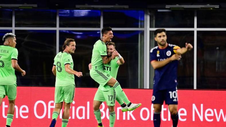 Sep 2, 2023; Foxborough, Massachusetts, USA;  Austin FC midfielder Emiliano Rigoni (7) celebrates his goal by jumping to the arms of midfielder Jon Gallagher (17) during the first half at Gillette Stadium. Mandatory Credit: Eric Canha-USA TODAY Sports