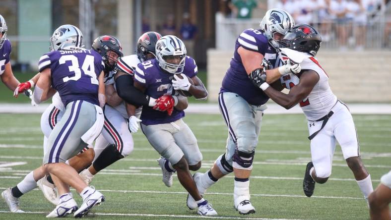 Sep 2, 2023; Manhattan, Kansas, USA; Kansas State Wildcats running back DJ Giddens (31) is tacked by Southeast Missouri State Redhawks defensive lineman LaWilliam Holmes (91) and linebacker Jacob Morrissey (44) during the second quarter at Bill Snyder Family Football Stadium. Mandatory Credit: Scott Sewell-USA TODAY Sports