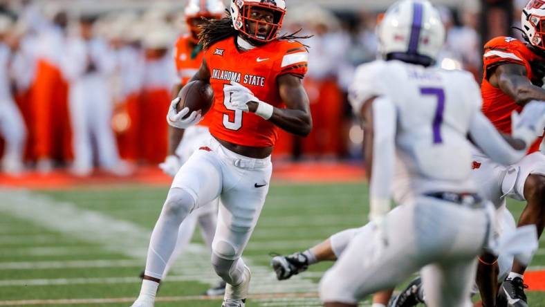 Sep 2, 2023; Stillwater, Oklahoma, USA; Oklahoma State's Kendal Daniels (5) returns a recovered a fumble against Central Arkansas in the second quarter at Boone Pickens Stadium. Mandatory Credit: Nathan J. Fish-USA TODAY Sports