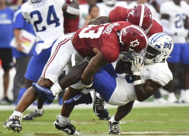 Sep 2, 2023; Tuscaloosa, Alabama, USA;  Alabama Crimson Tide defensive back Malachi Moore (13) and defensive back Caleb Downs (2) combine to tackle Middle Tennessee Blue Raiders wide receiver Elijah Metcalf (9) during the first half at Bryant-Denny Stadium. Mandatory Credit: Gary Cosby Jr.-USA TODAY Sports