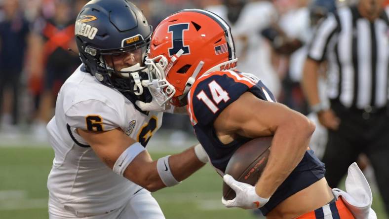 Sep 2, 2023; Champaign, Illinois, USA;  Toledo Rockets safety Nate Bauer (6) tries to tackle Illinois Fighting Illini wide receiver Casey Washington (14) during the first half at Memorial Stadium. Mandatory Credit: Ron Johnson-USA TODAY Sports