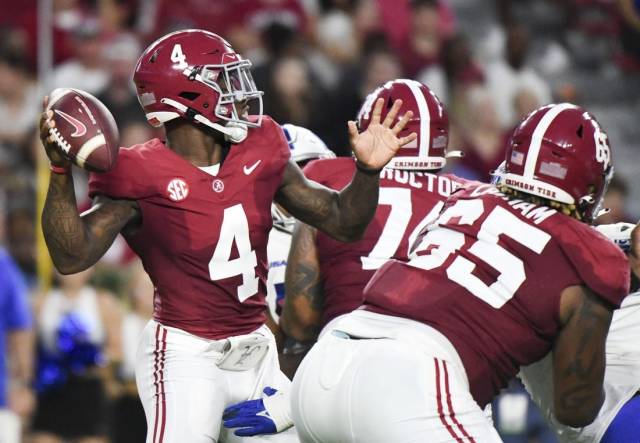 Sep 2, 2023; Tuscaloosa, Alabama, USA;  Alabama Crimson Tide quarterback Jalen Milroe (4) throws behind a block by offensive lineman JC Latham (65) against the Middle Tennessee Blue Raiders during the first half at Bryant-Denny Stadium. Mandatory Credit: Gary Cosby Jr.-USA TODAY Sports