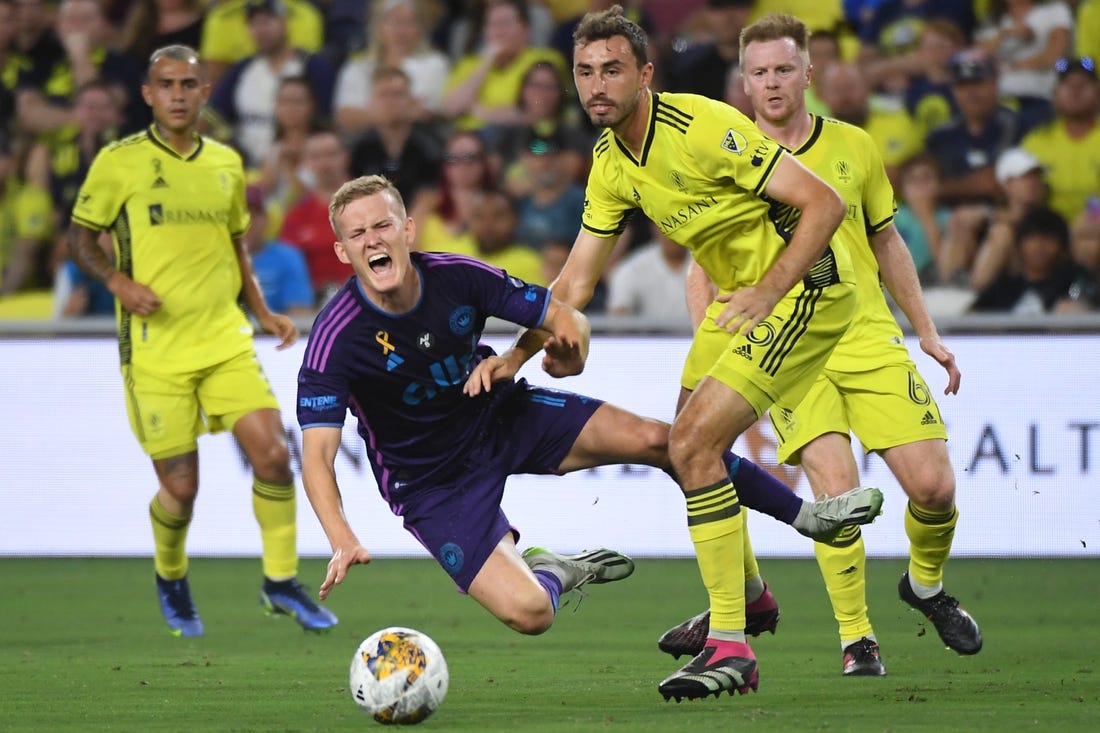 Sep 2, 2023; Nashville, Tennessee, USA; Charlotte FC forward Karol Swiderski (11) in action against Nashville SC defender Jack Maher (5) during the first half at Geodis Park. Mandatory Credit: Christopher Hanewinckel-USA TODAY Sports