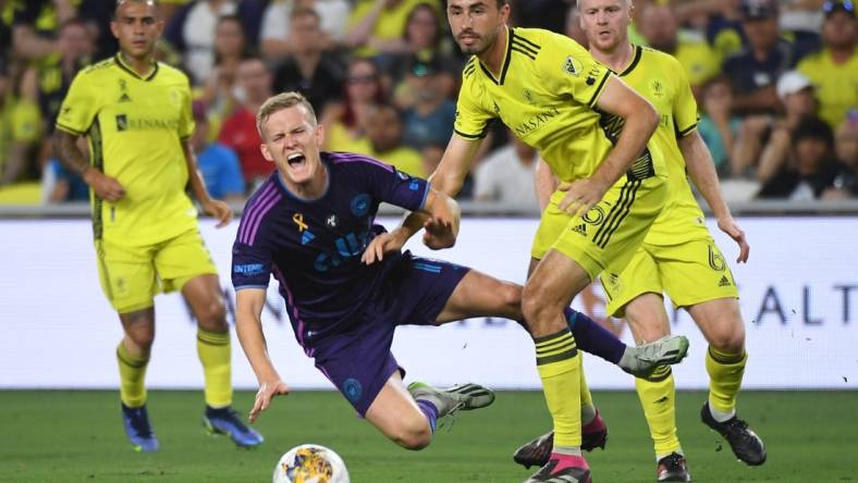 Sep 2, 2023; Nashville, Tennessee, USA; Charlotte FC forward Karol Swiderski (11) in action against Nashville SC defender Jack Maher (5) during the first half at Geodis Park. Mandatory Credit: Christopher Hanewinckel-USA TODAY Sports