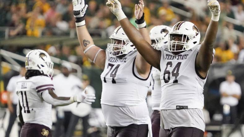 Sep 2, 2023; Waco, Texas, USA; Texas State Bobcats offensive lineman Caleb Johnson (74) and offensive lineman Dorion Strawn (64) celebrate a touchdown against the Baylor Bears during the second half at McLane Stadium. Mandatory Credit: Raymond Carlin III-USA TODAY Sports